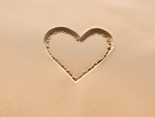 Wall Mural - heart shape drawn in sand on beach