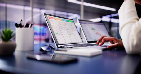 Poster - Focused African American woman using laptop to manage business schedule