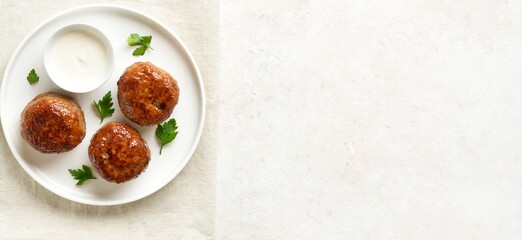 Wall Mural - Minced pork and beef cutlets with sauce on plate on white background