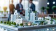 © Achmad Khoeron - real estate developers, architects and businessmen team working on new business buildings project in office. complex scale model on the table