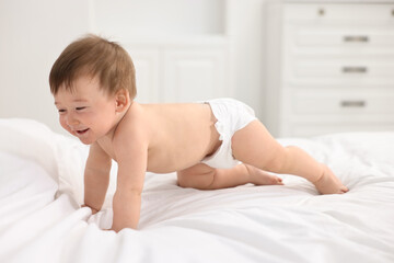 Canvas Print - Happy baby boy crawling on bed at home