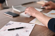 © New Africa - Cartographer working with cadastral maps at wooden table in office, closeup
