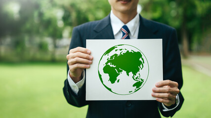 Wall Mural - Environment World Earth Day Concept. Business company responsible environmental, social, and governance. green business Organization Sustainable development environmental. holding a sign save earth.