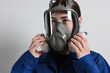 © New Africa - Worker in respirator mask on grey background