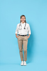 Canvas Print - Portrait of happy doctor with stethoscope on light blue background