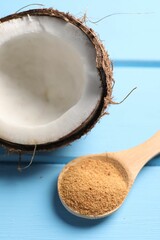 Poster - Spoon with coconut sugar and half of fruit on light blue wooden table, closeup