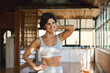 © insta_photos - Happy fit young Hispanic woman in her 30s advertising yoga classes. Smiling sporty healthy active lady yoga coach wearing sportswear standing in yoga gym studio with big windows looking away. Portrait