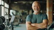 © gn8 - Elderly Fitness Trainer Smiling Warmly in Gym, Promoting Active Lifestyle and Wellbeing, Ideal for Health and Wellness Campaigns