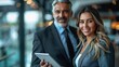 © Pixel Mind - A man and a woman in business attire work together on a tablet in a modern office setting