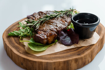 Pork steak with sauce on a wooden board