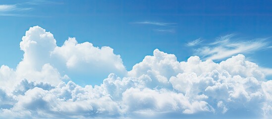 Wall Mural - The clear blue sky featuring fluffy white clouds creates a perfect copy space image