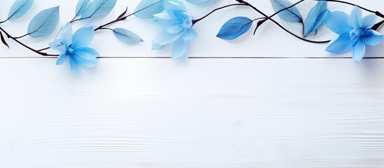 blue beauty product gel and leaf buds on white wood table. copy space available