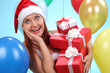 © zhagunov_a - christmas.smiling woman in santa helper hat with gift boxes