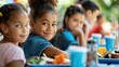 © buraratn - Children sitting at a lunch table, enjoying their meals and catching up on back to school