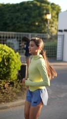 Wall Mural - Young Woman engages in Jogging in the Park on a Sunny Day for Fitness and Health