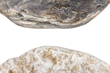 Wall Mural - Edges of two pebbles isolated on white background