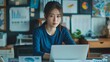 © ifoto - A businesswoman sitting at her desk in front of the laptop
