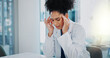© peopleimages.com - Doctor, woman and headache at hospital with stress, anxiety and burnout at desk with pain. Frustrated, medical and healthcare employee with brain fog, tired and fatigue from clinic issue of surgeon