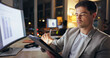 © peopleimages.com - Businessman, working and night workplace with tablet, statistical analyst and analyzing project or sales report on computer. Online, graphs and internet research, overtime and email stats in office