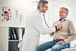 © Reese Coop/peopleimages.com - Consultation, man and doctor in office with stethoscope, checkup and healthcare at senior clinic. Diagnosis, elderly patient and medical professional with support, checking heart health and advice