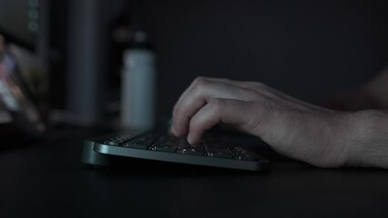Typing on a keyboard, close-up side view, cinematic shot
