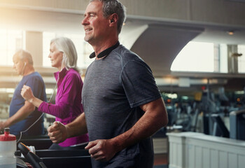 Exercise, treadmill and senior people running in gym for workout, physical health and wellness in retirement. Group, jogging or training together for cardio, walking and fitness or endurance