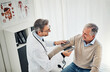 © Reese Coop/peopleimages.com - Blood pressure, man and doctor in office with discussion, help and advice for hypertension on bed. Clinic, senior patient and happy medical professional with support, trust and assessment at checkup