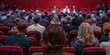 © RABEYAAKTER - A group of people sitting in an auditorium with back view