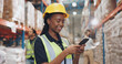© peopleimages.com - Logistics, woman and phone in warehouse in communication, stock and safety in supply chain or freight. Factory, officer and industry for quality control in manufacturing, shipping in trade or export