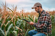 © Prasanth - A modern farmer in a corn field using a digital tablet to review harvest and crop performance, ESG concept and application of technology in contemporary agriculture practices, generative ai