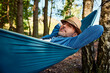 © baranq - Carefree man lying in hammock