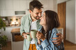 © Miljan Živković - Boyfriend and girlfriend enjoy their first morning coffee at kitchen