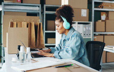 Canvas Print - Courier business, woman and laptop in office for ecommerce, online service and manage delivery. Female owner, supplier and computer for typing, digital inventory and headphones for radio podcast