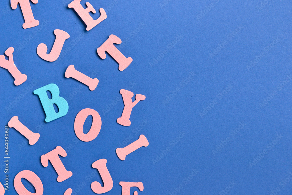 One blue letter among pink ones on color background. Concept of uniqueness