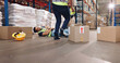 © peopleimages.com - Accident, fall and stock with man in warehouse for delivery, distribution or supply chain logistics. Fail, injury or mistake and person on floor of plant with box for ecommerce, retail or safety