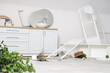 © Pixel-Shot - Counters with overturned shelf unit and folding screen in messy bathroom