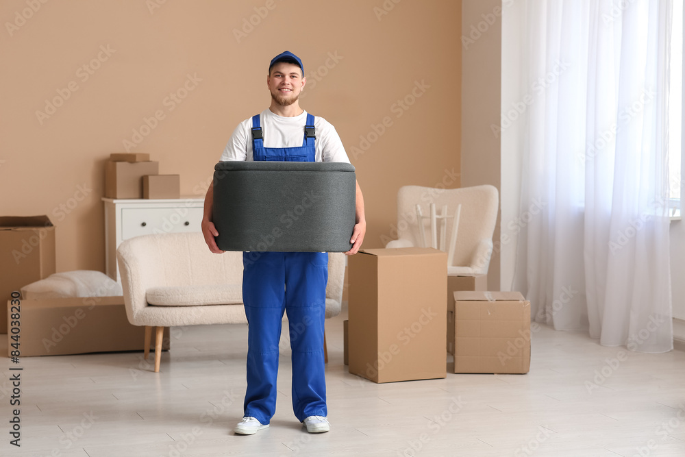 Loader carrying ottoman at home on moving day