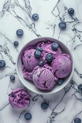 Wall Mural - A bowl filled with fresh blueberries and ice cream on a white marble surface