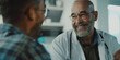 © RealPeopleStudio - A close-up of an African American doctor talking to a male patient during a routine medical checkup, with a reassuring smile