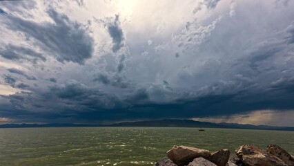 Wall Mural - Storm system moving over Utah Lake during summer monsoon as clouds move through the sky.