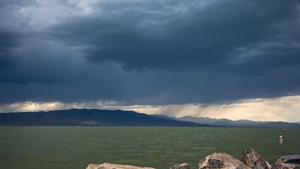 Wall Mural - Storm clouds moving in time lapse over Utah Lake during summer rainstorm.