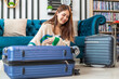 © Art_Photo - Portrait of backpacker beauty asian traveler woman packing prepare stuff and outfit clothes in suitcases travel bag luggage for summer, holiday, weekend, tourist, journey, vacation trip at home.travel