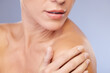 © Courtney Haas/peopleimages.com - Woman, shoulder and skincare in studio for touch, soft and treatment or cosmetics on blue background. Female person, healthy and pamper for dermatology, grooming and confident for wellness or beauty