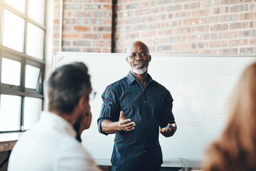 Wall Mural - Meeting, man and presentation on whiteboard in office for feedback, planning and ideas of strategy development. Male presenter, leadership and workshop for coaching group with business proposal pitch