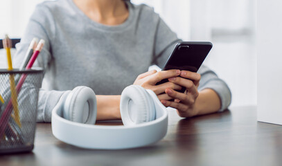 Woman holding a smartphone and using social media on internet.