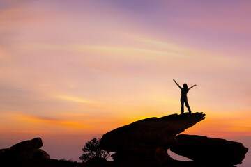 Wall Mural - Female  hiker enjoying the beautiful sunset from mountain top.