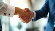© Haru Works - 握手するビジネスマンの手元
