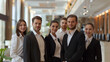 © Aloka - A professional hotel staff team standing together in the hotel lobby, all looking at the camera with friendly smiles,. Ai generated