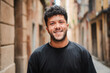 © Jose Calsina - Close up individual portrait of one arab male smiling and looking at camera outside. Young adult arabic guy staring front and laughing with friendly expression. Joyful man with carefree attitude