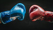 © Oleksandr - two boxing gloves fighting each other on black background. one blue and the another red